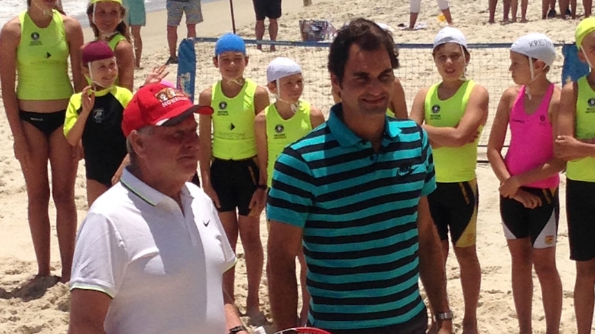 Colin Barnett and Roger Federer at Cottesloe Beach as young lifesavers look on.