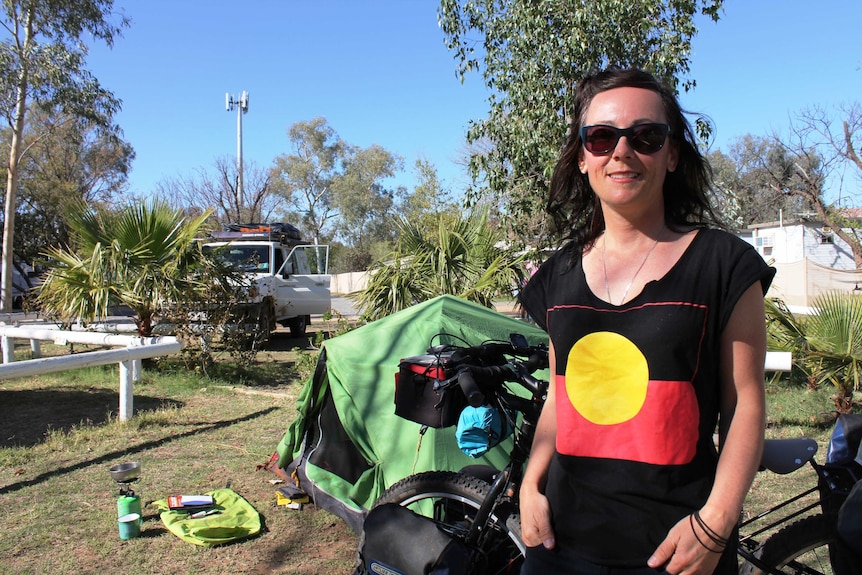 A profile shot of Rachel Everitt standing at her campsite