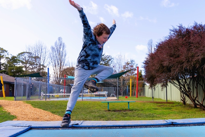 A boy jumping on a trampoline 