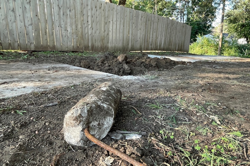Dirt and a concrete stump 