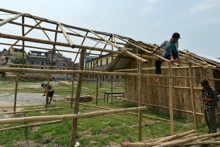 Nepalese workers build temporary classrooms
