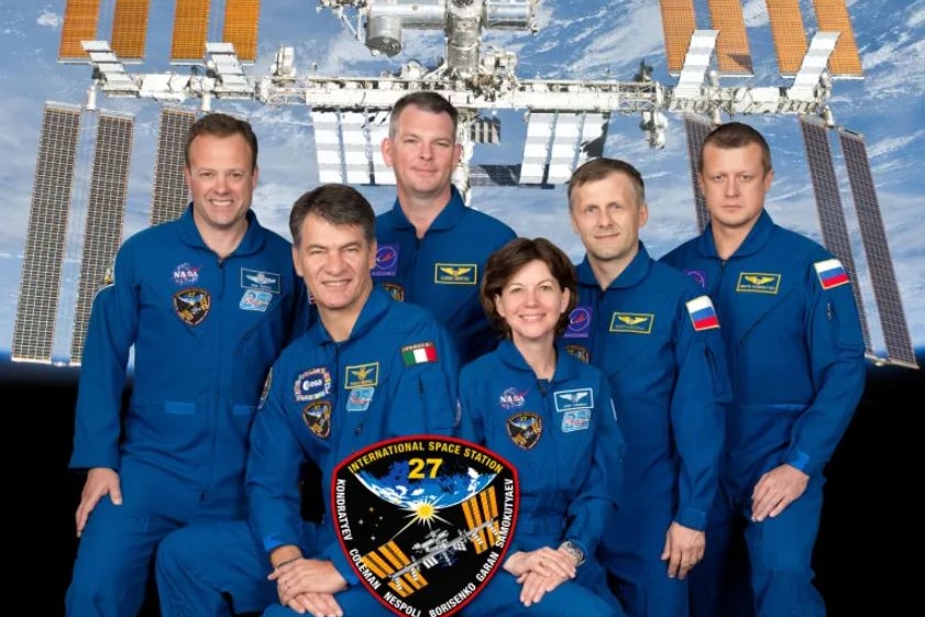 A group photo of astronauts in blue uniforms