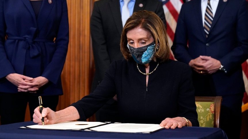 House Speaker Nancy Pelosi of Calif., signs the article of impeachment against President Donald Trump