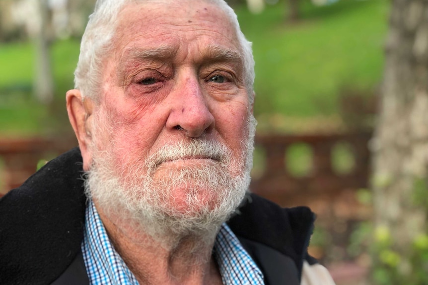 A tight head shot of Ian Stewart posing for a photo outdoors.