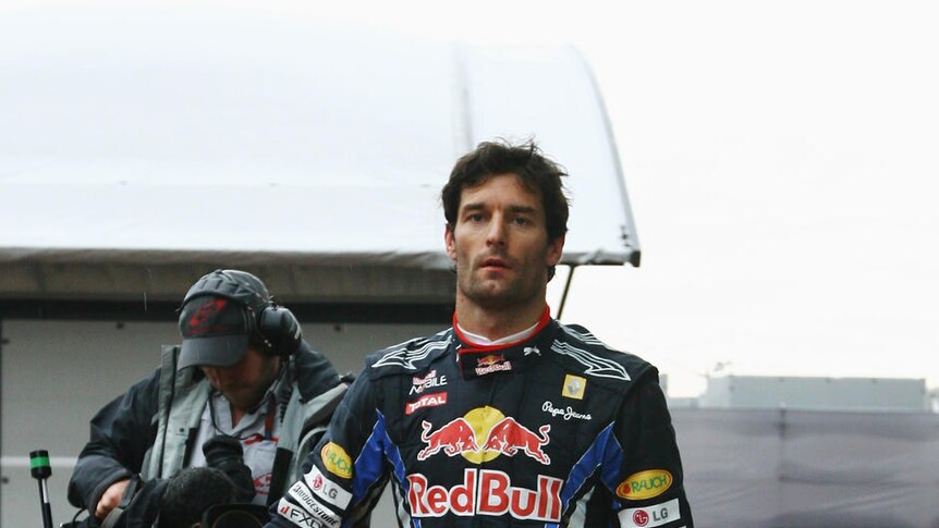 Title blow... a disappointed Mark Webber heads back to the Red Bull garage after crashing out