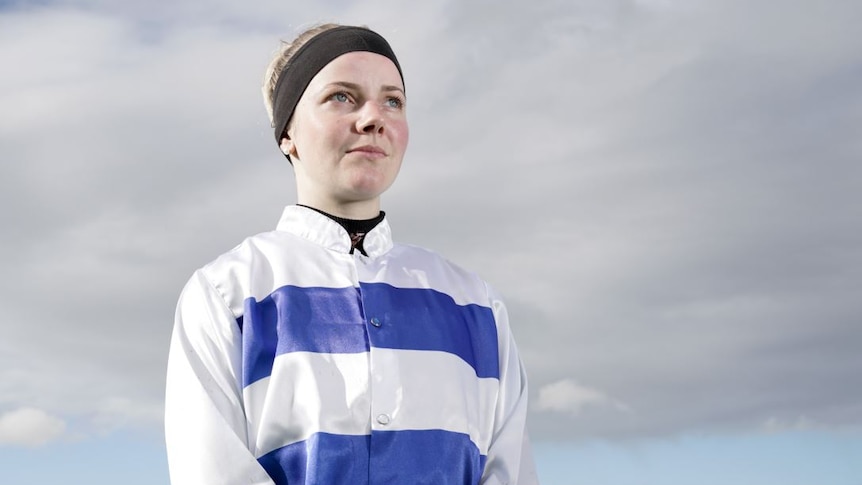 A woman wearing a blue and white striped jumper