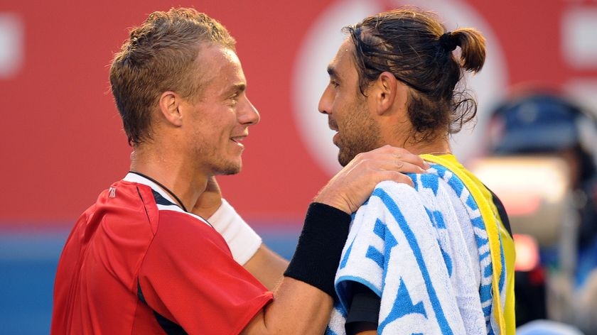 Time to move on...Hewitt consoles Baghdatis after the Cypriot retired hurt.