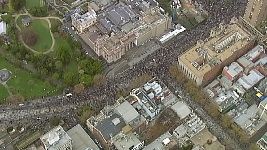A crowd on the streets outside Victoria's Parliament in Melbourne, photographed from the air.