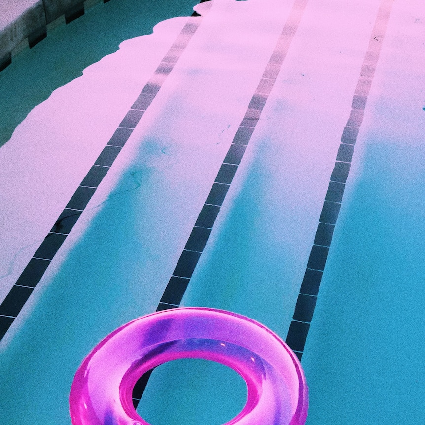 Swimming pool and floating pink rubber ring
