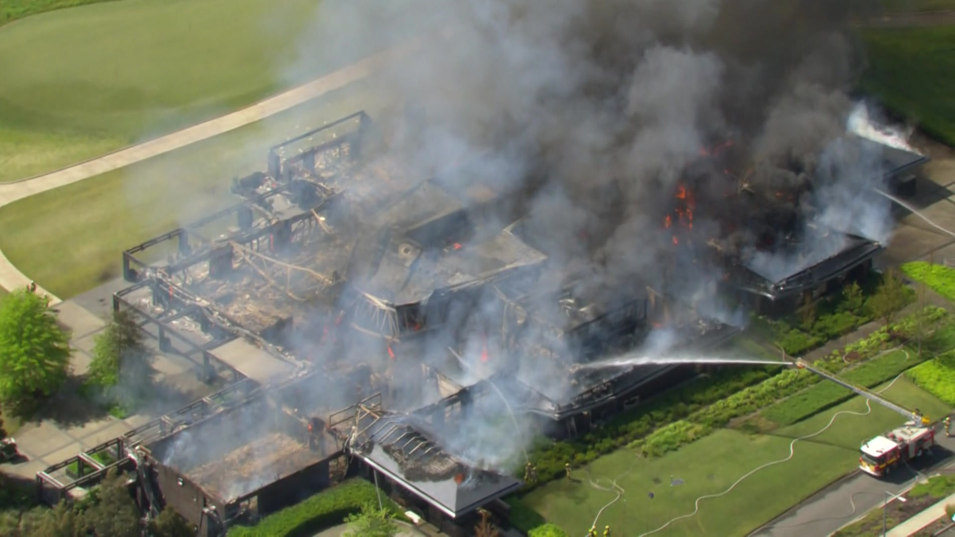 A building on fire at a golf course
