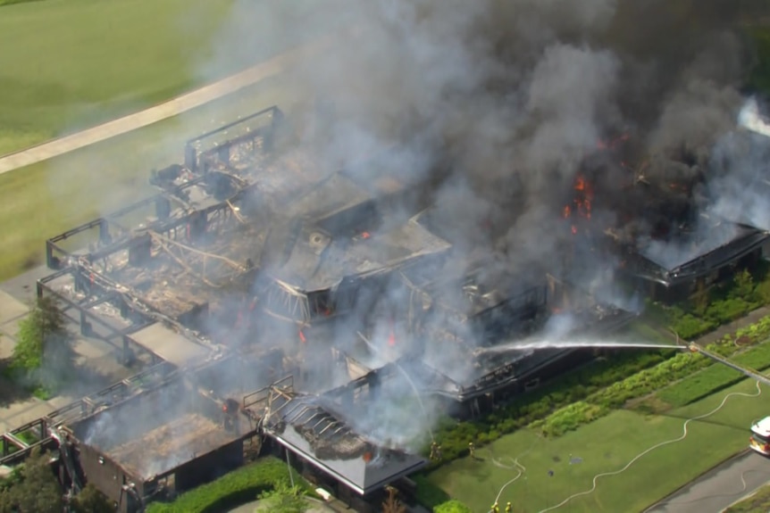 A building on fire at a golf course