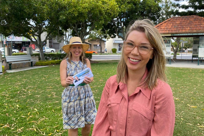 Kate Jones holding Jonty Bush flyers standing next to Jonty Bush in a park