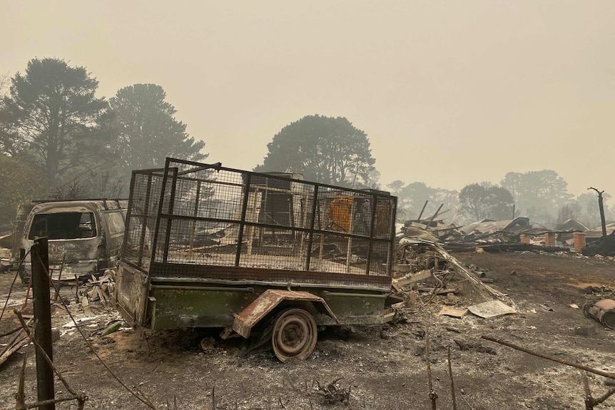 destroyed vehicles and trailers after a fire