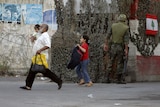 A family flees after violence erupts in the Ain al-Hilweh refugee camp in southern Lebanon.