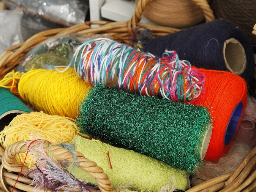 Colourful yarns in a basket.