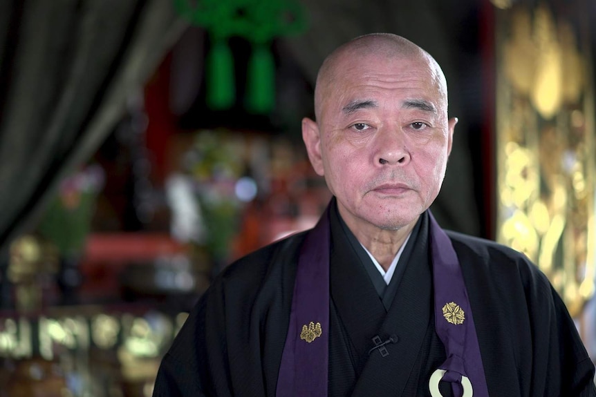 An elderly male Japanese Buddhist priest.