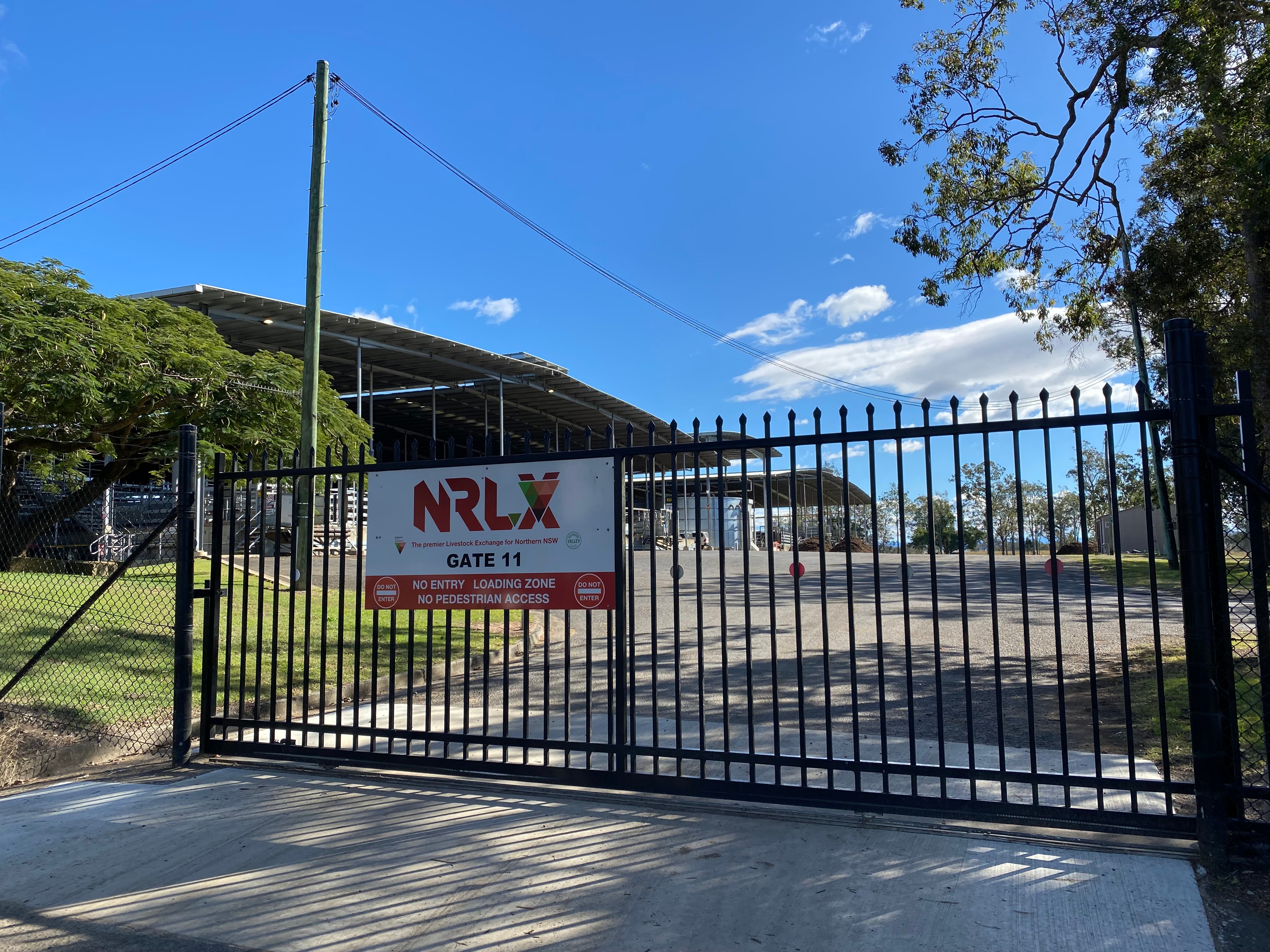 Black steel gates closed with an NRLX sign on front.