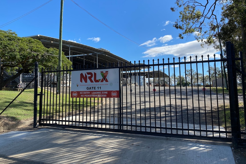 Black steel gates closed with an NRLX sign on front.