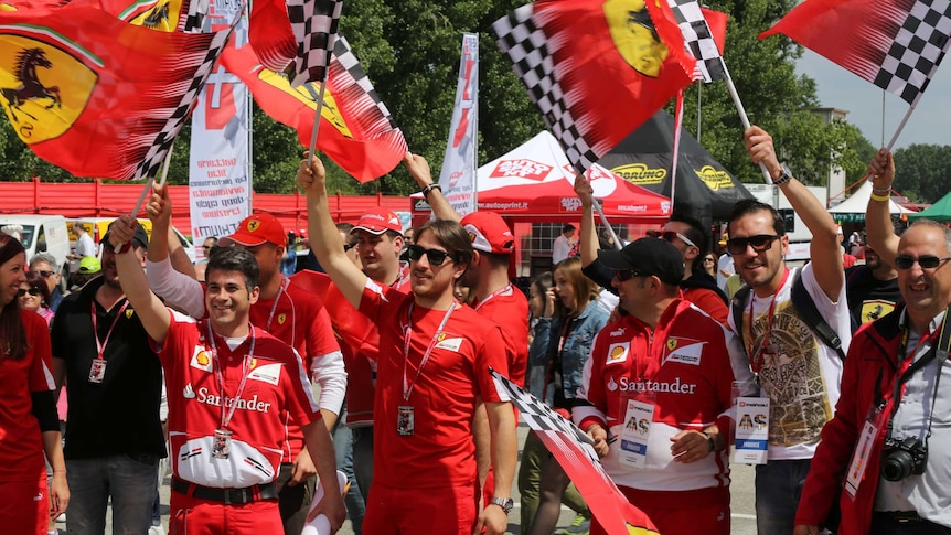 Ferrari fans wave flags in tribute to Ayrton Senna on 20th anniversary of his death on May 1, 2014.