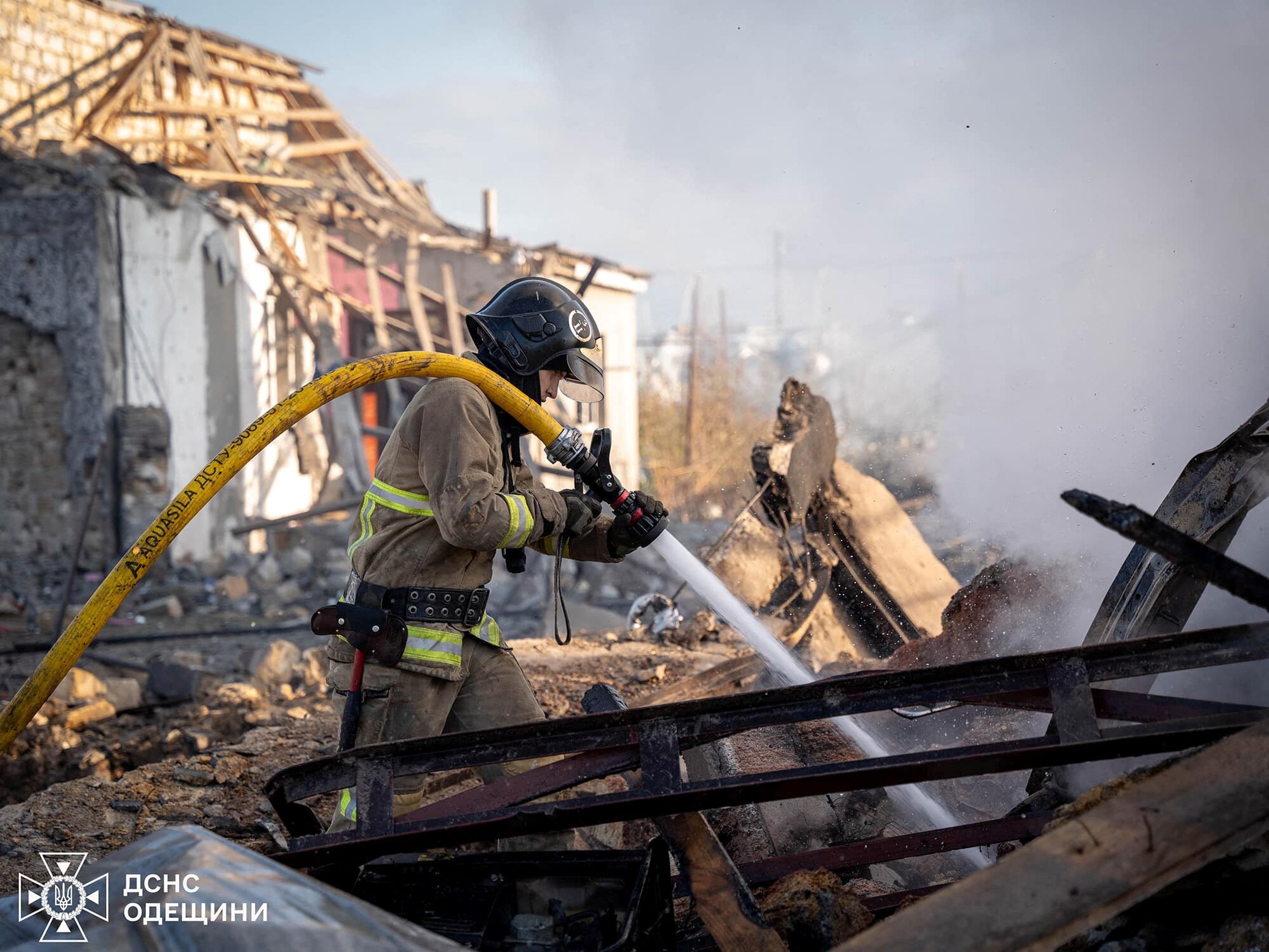 firefighter puts hoses hose and puts out fire