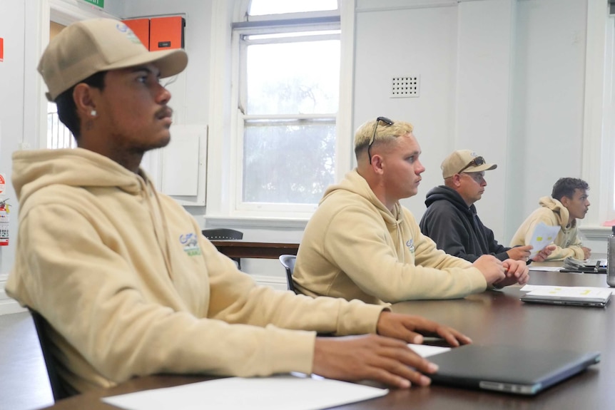 Gamay Rangers sit at desks during a language lesson.