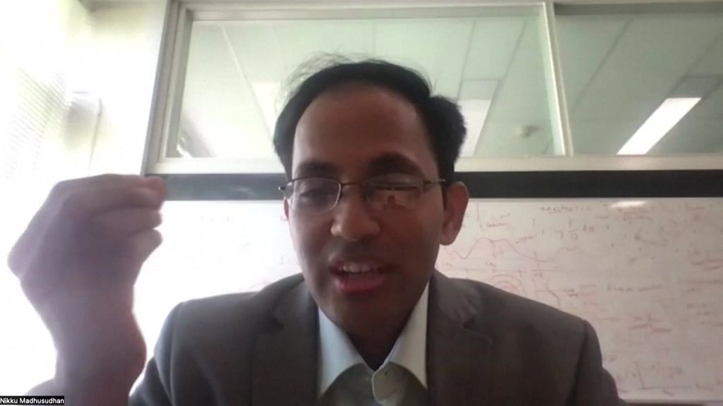 Indian Professor with glasses speaking while doing Italian hand gesture. 