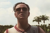 young man in singlet and sunglasses