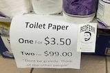 Close up of toilet paper on the shelf in a supermarket with price tag, 'one for $3.50, two for $99, don't be greedy'