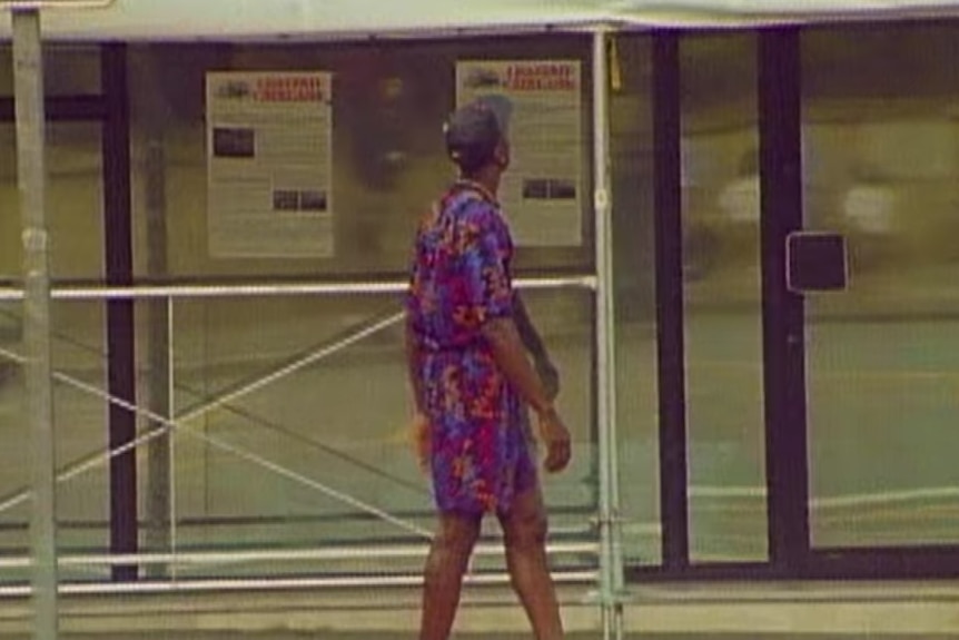 Michael Jordan turns away from the camera as he walks on the street.