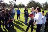 Gillard with football at junior footy club