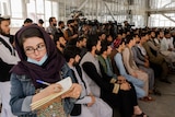 An Afghan female journalist attends a Taliban officials news conference.