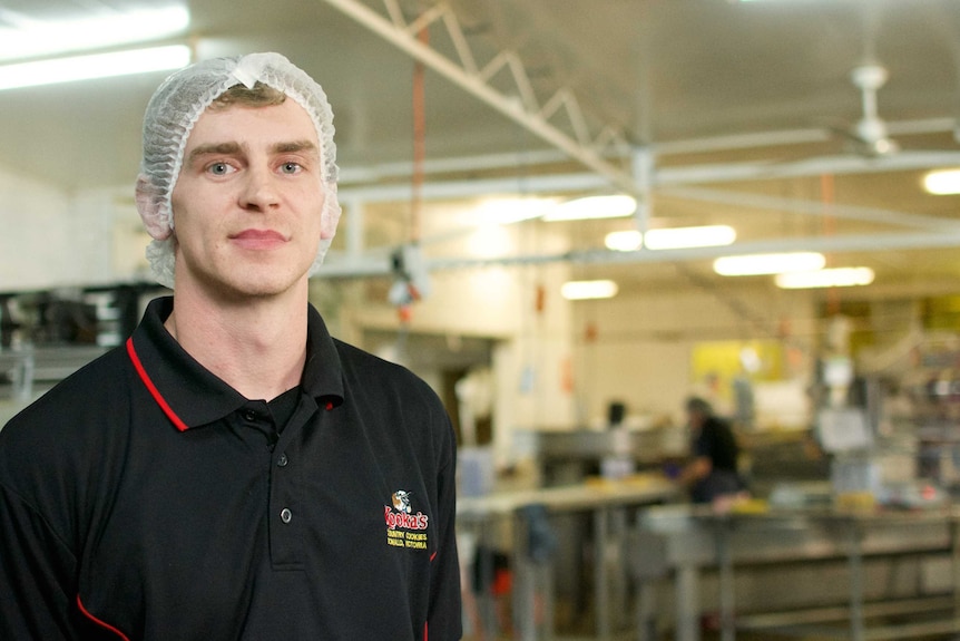 Kooka's Country Cookies production manager Damian O'Toole wears a hairnet in a factory