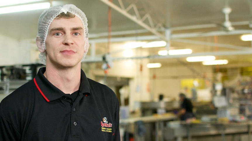 Kooka's Country Cookies production manager Damian O'Toole wears a hairnet in a factory