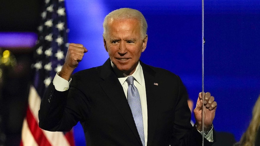 President-elect Joe Biden gestures with his fist