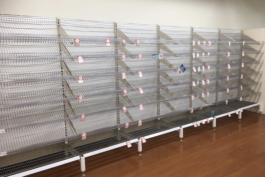 Empty shelves at an Ingham supermarket where residents have begun stockpiling supplies.