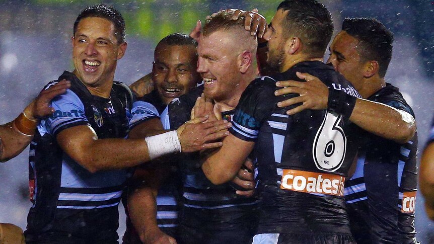 Luke Lewis of the Sharks celebrates his try