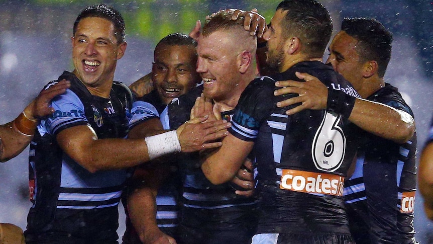 Luke Lewis of the Sharks celebrates his try