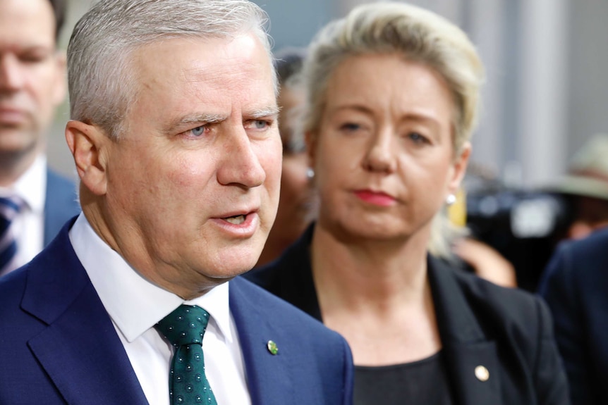 Michael McCormack stands in front of his colleagues addressing the media. Bridget McKenzie is next to him