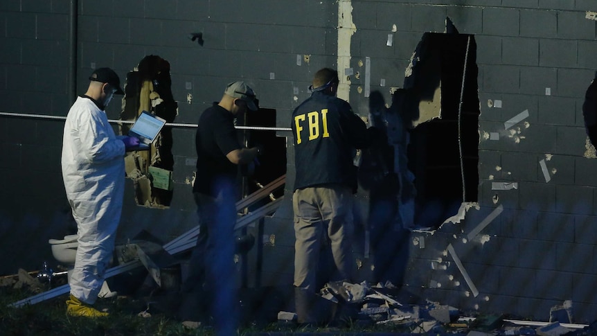 Police forensic investigators work at the crime scene