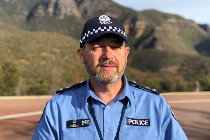 A close up of acting superintendent Alex Ryan in front of Bluff Knoll.