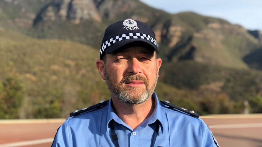 A close up of acting superintendent Alex Ryan in front of Bluff Knoll.