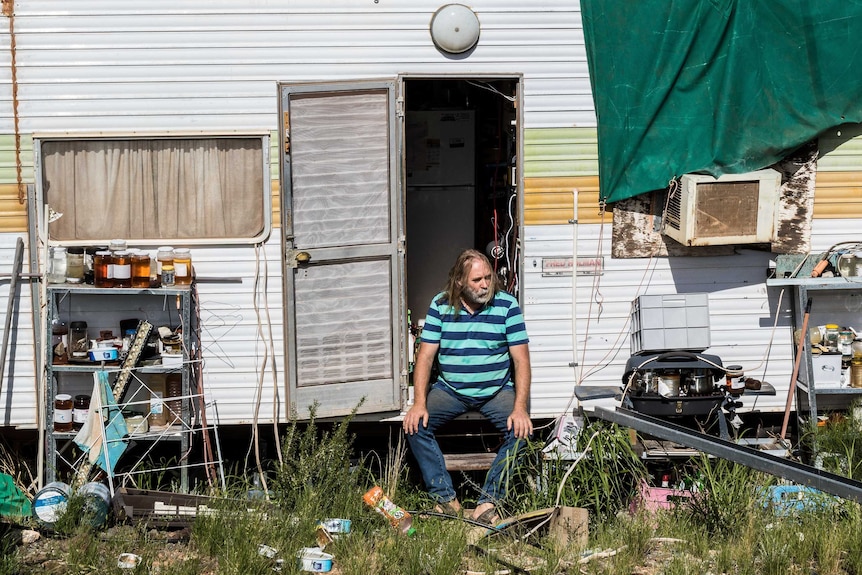 Mr Gopel sits at the entrance to his caravan.