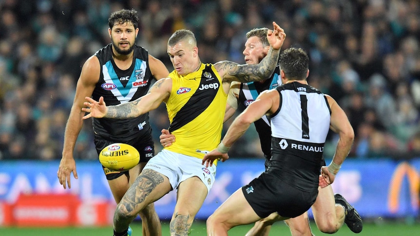 Dustin Martin kicks out of a Power pack