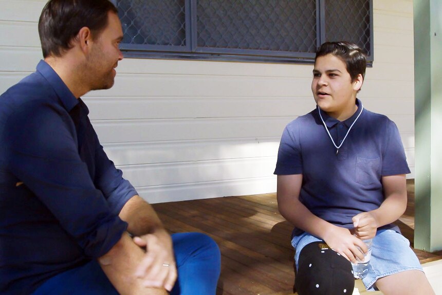 Allan Clarke and Year 9 student David Scott talking on a veranda at the Bourke High School.