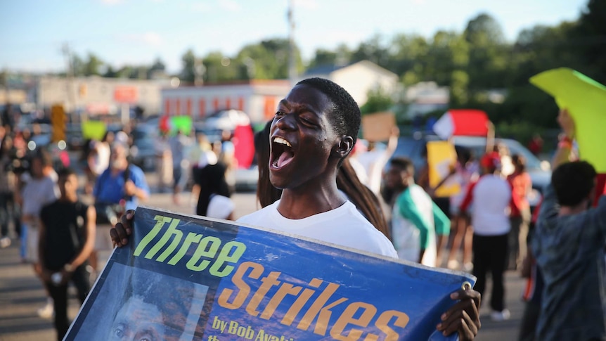 Demonstrators protest the killing of teenager Michael Brown on August 12, 2014 in Ferguson, Missouri.