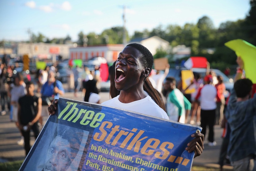 Demonstrators protest the killing of teenager Michael Brown on August 12, 2014 in Ferguson, Missouri.