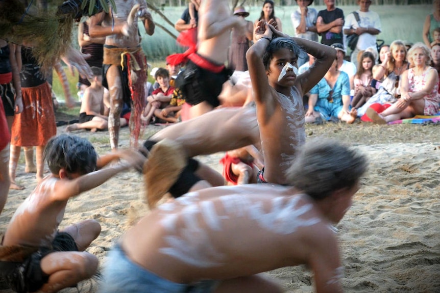 Young Aboriginal dancers performing to a crowd