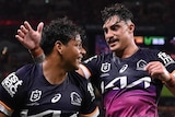 Two Brisbane Broncos NRL players celebrate a try against the Dolphins.