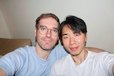 Couple take a selfie, Trent is on the left, partner Jongukk on the right.