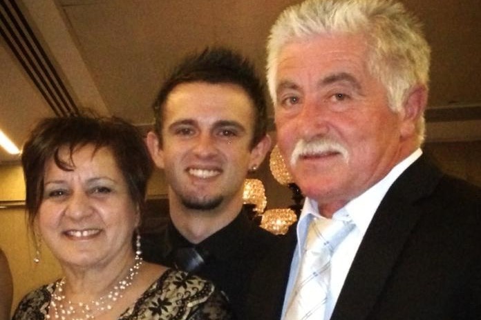 Donna, Mark and Leo Biancofiore, dressed for a formal occasion, smile at the camera.